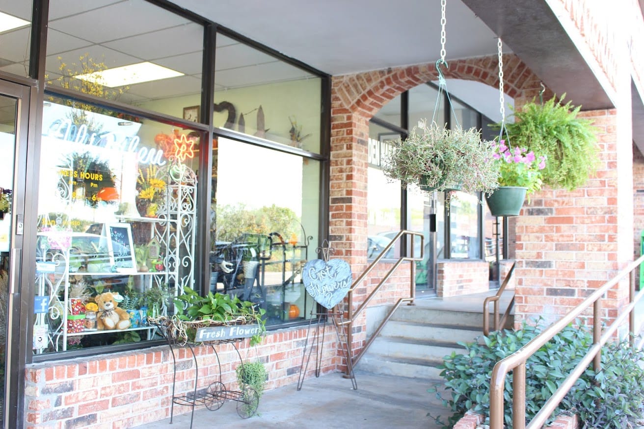 Flower shop entrance with hanging planters and display window
