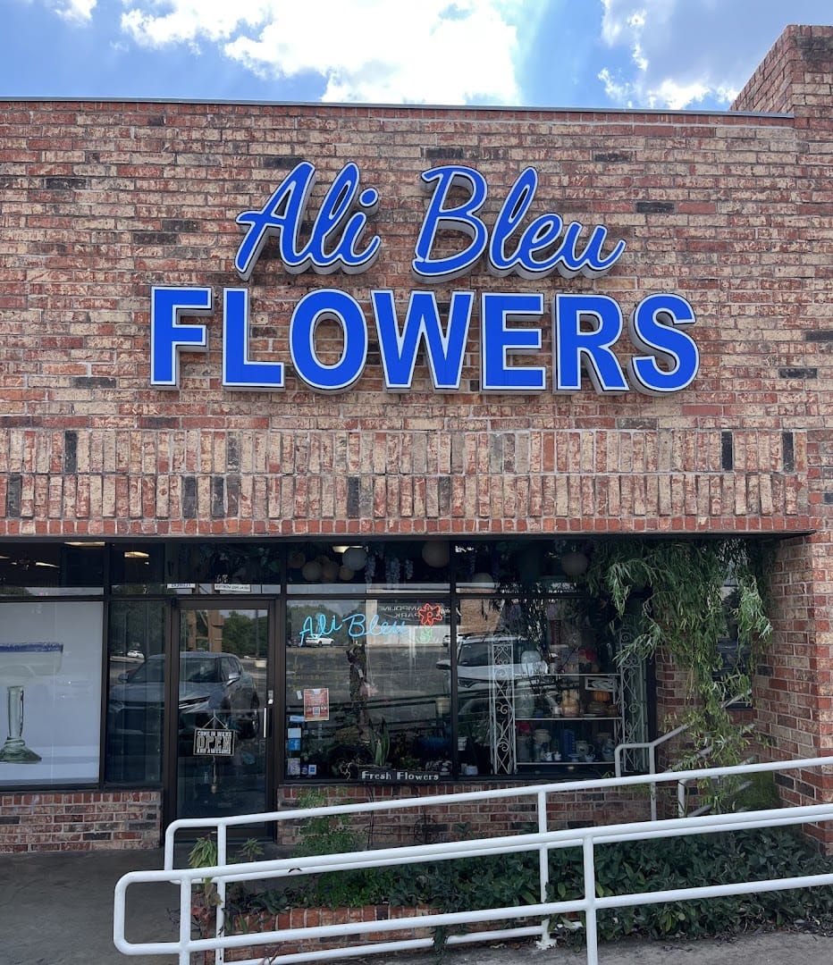 Brick storefront exterior with blue Ali Bleu Flowers sign