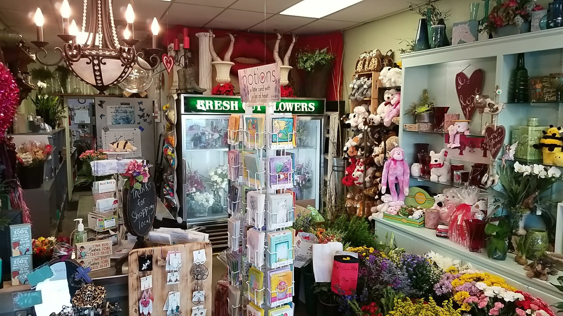 Inside the flower shop displaying gifts, cards, and fresh flowers