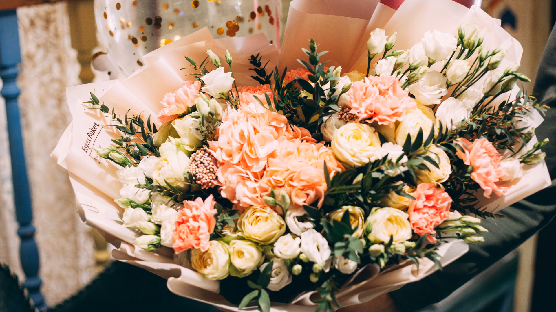 Beautiful close-up of a vibrant flower bouquet featuring roses and carnations, perfect for celebrations.